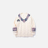Front view of the apricot Plaid Accent Knit Sweater in a gray background